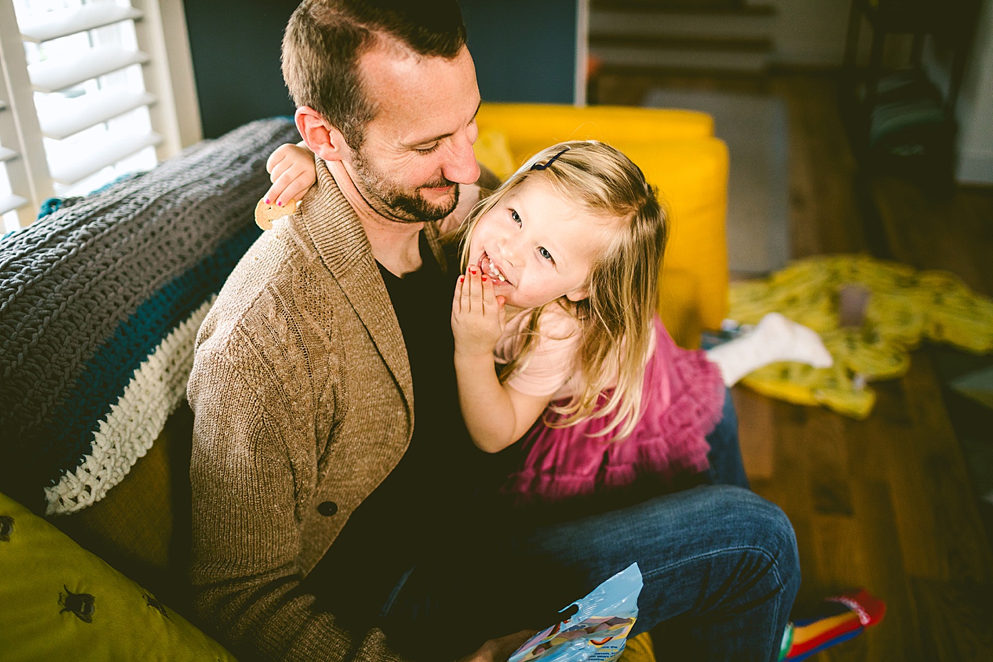 Daughter smiling at her dad in living room