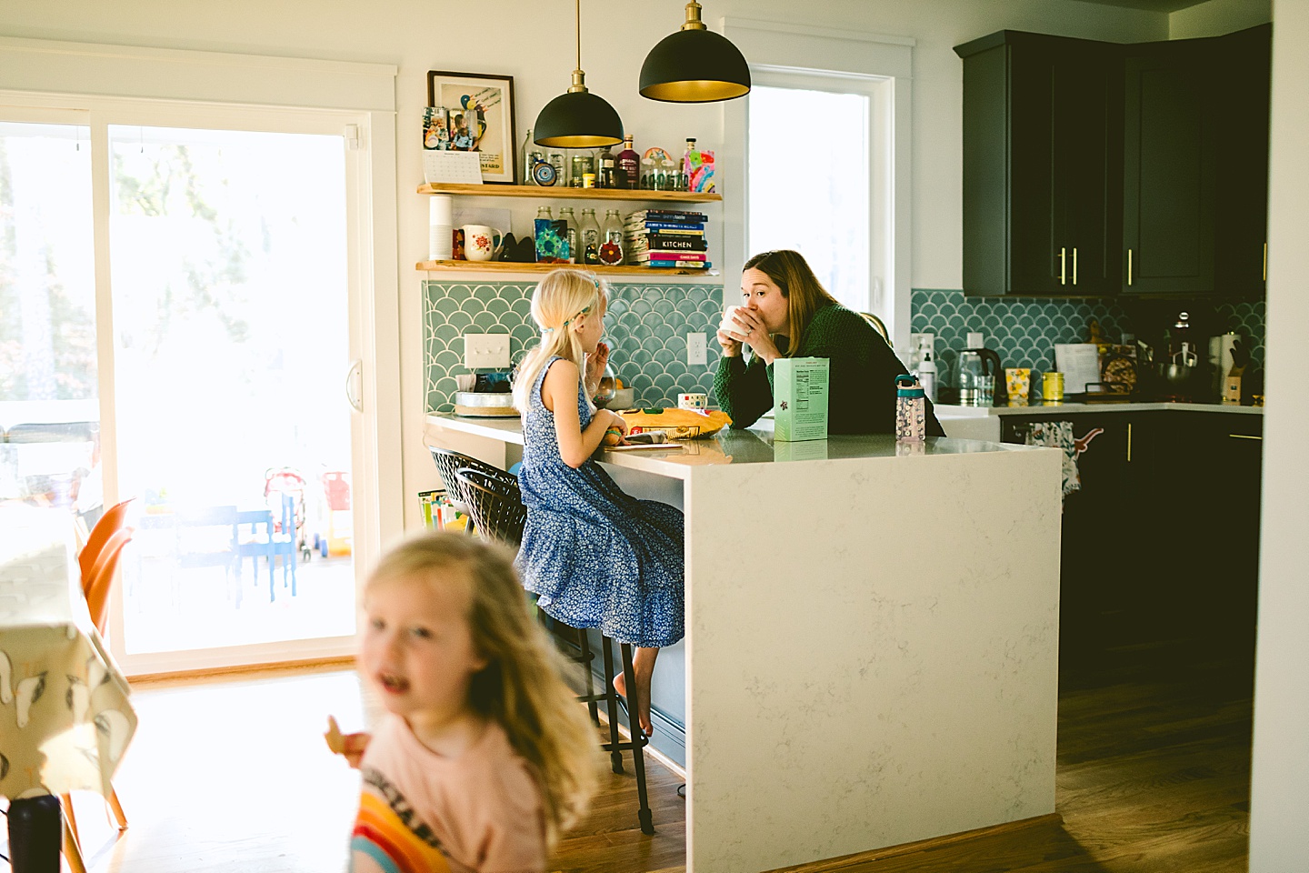 Girl reading a book at kitchen counter