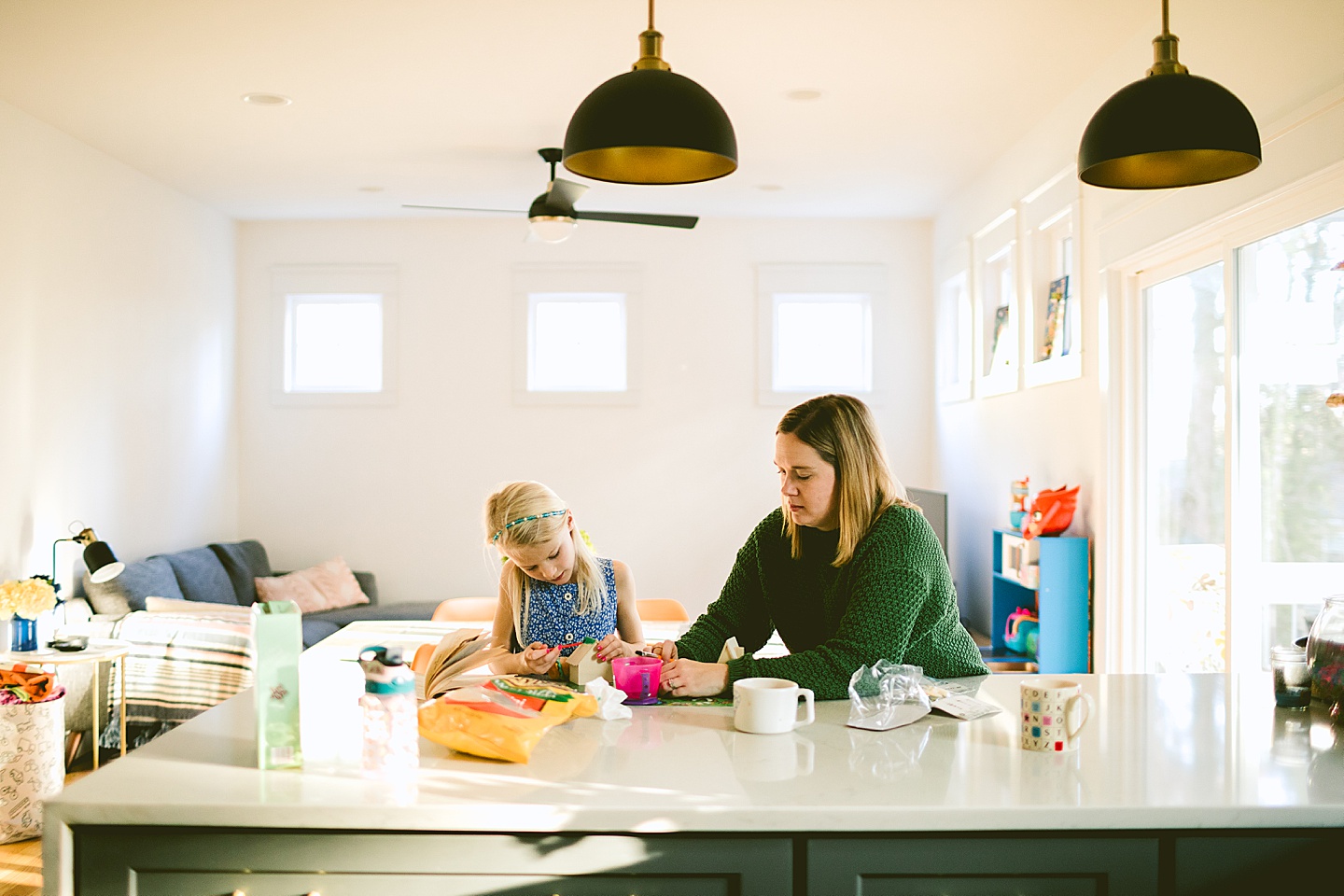 Mom and daughter do crafts in kitchen