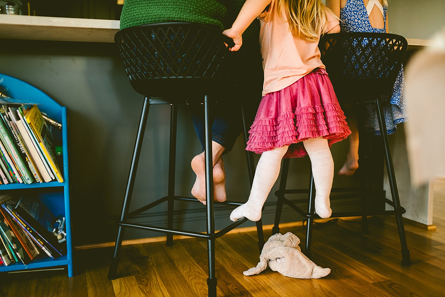 Girl standing on bar stool chair