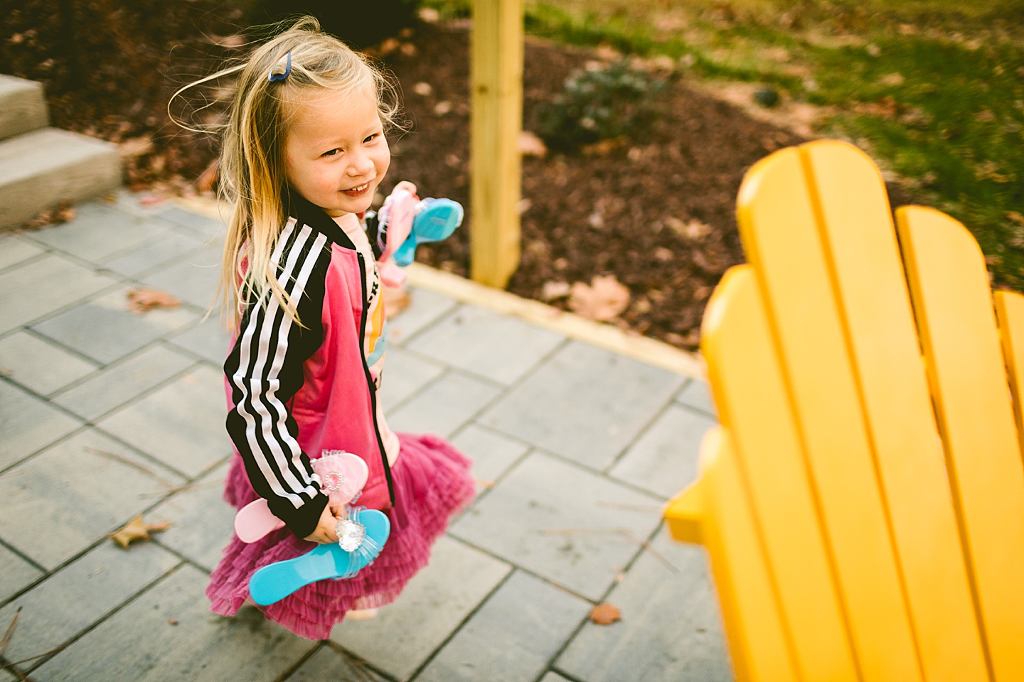 Girl running around patio with play shoes