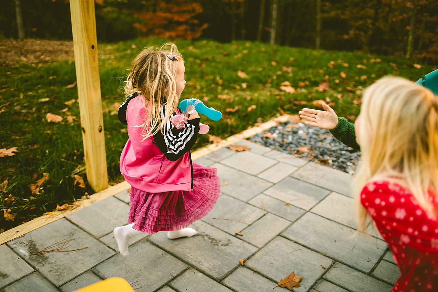 Girl running around patio with play shoes