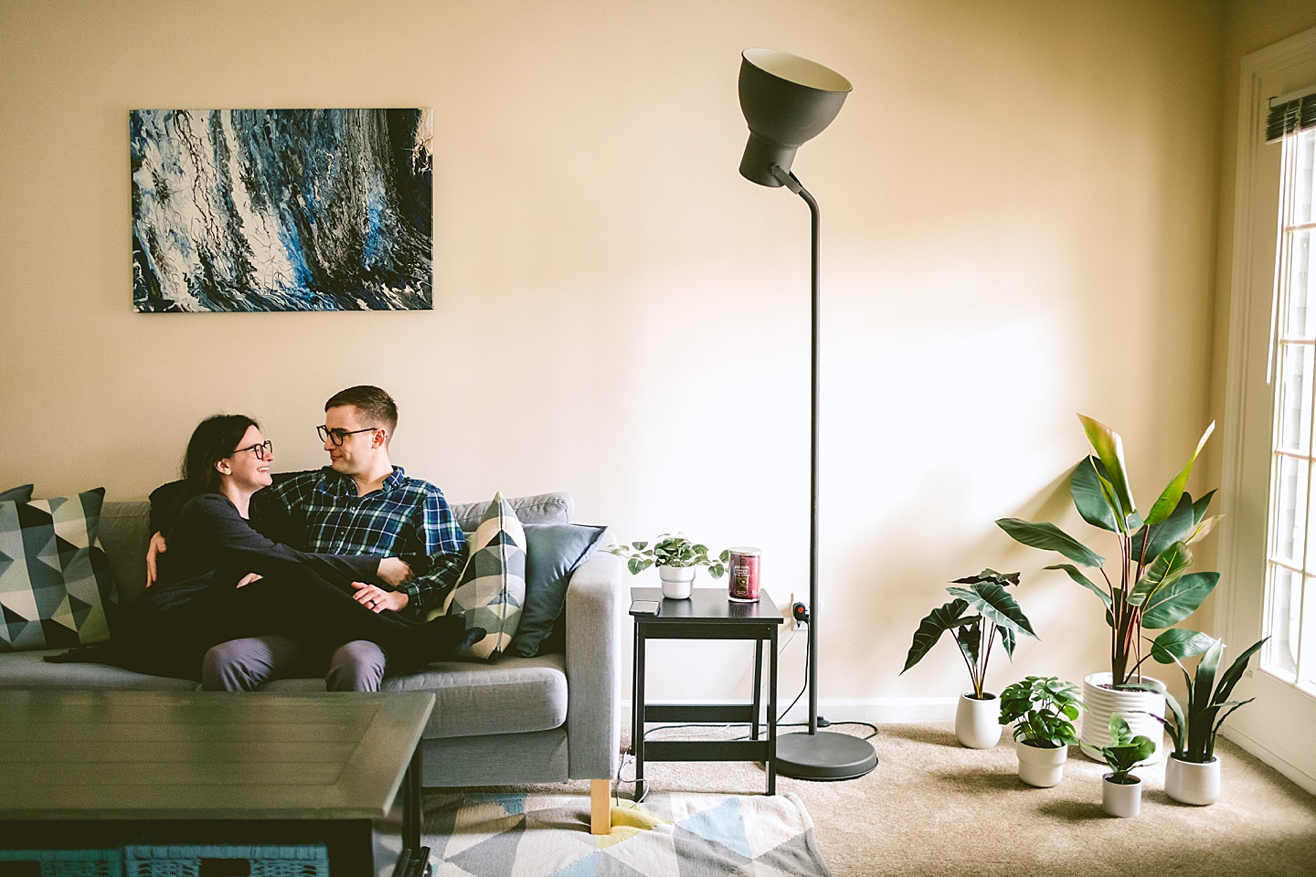 Couple sitting in their living room during wedding anniversary photos