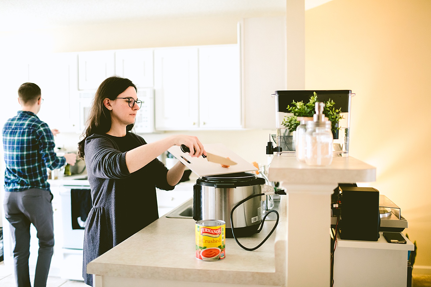 Couple making dinner together in kitchen at their home