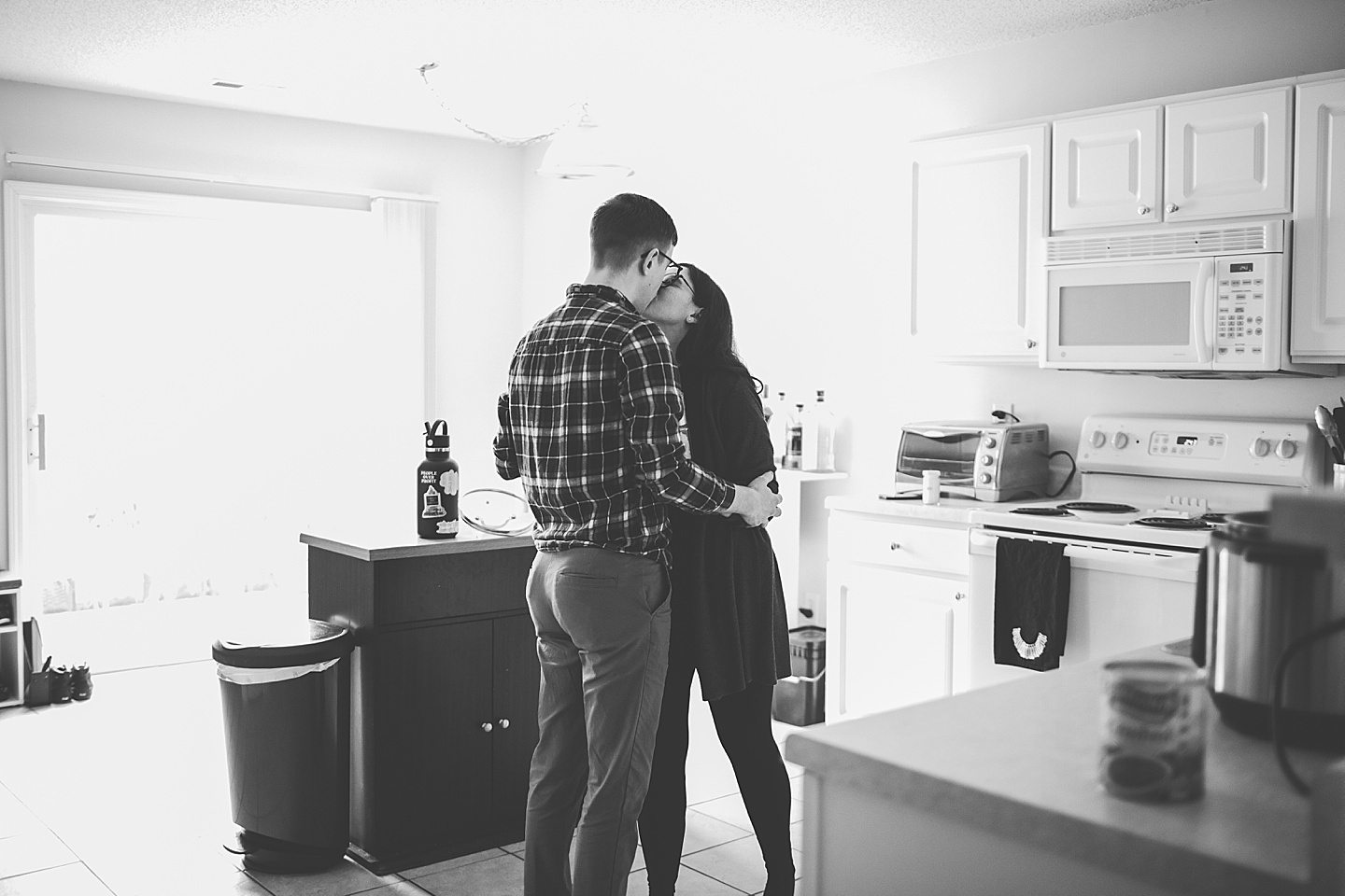 Couple making dinner together in kitchen at their home