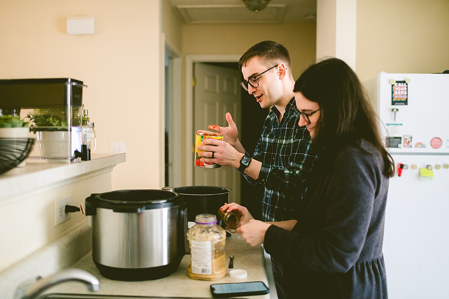 Couple making dinner together in kitchen at their home