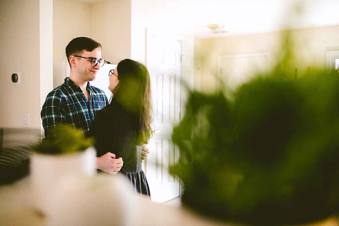 Couple hugging in kitchen at home in Raleigh