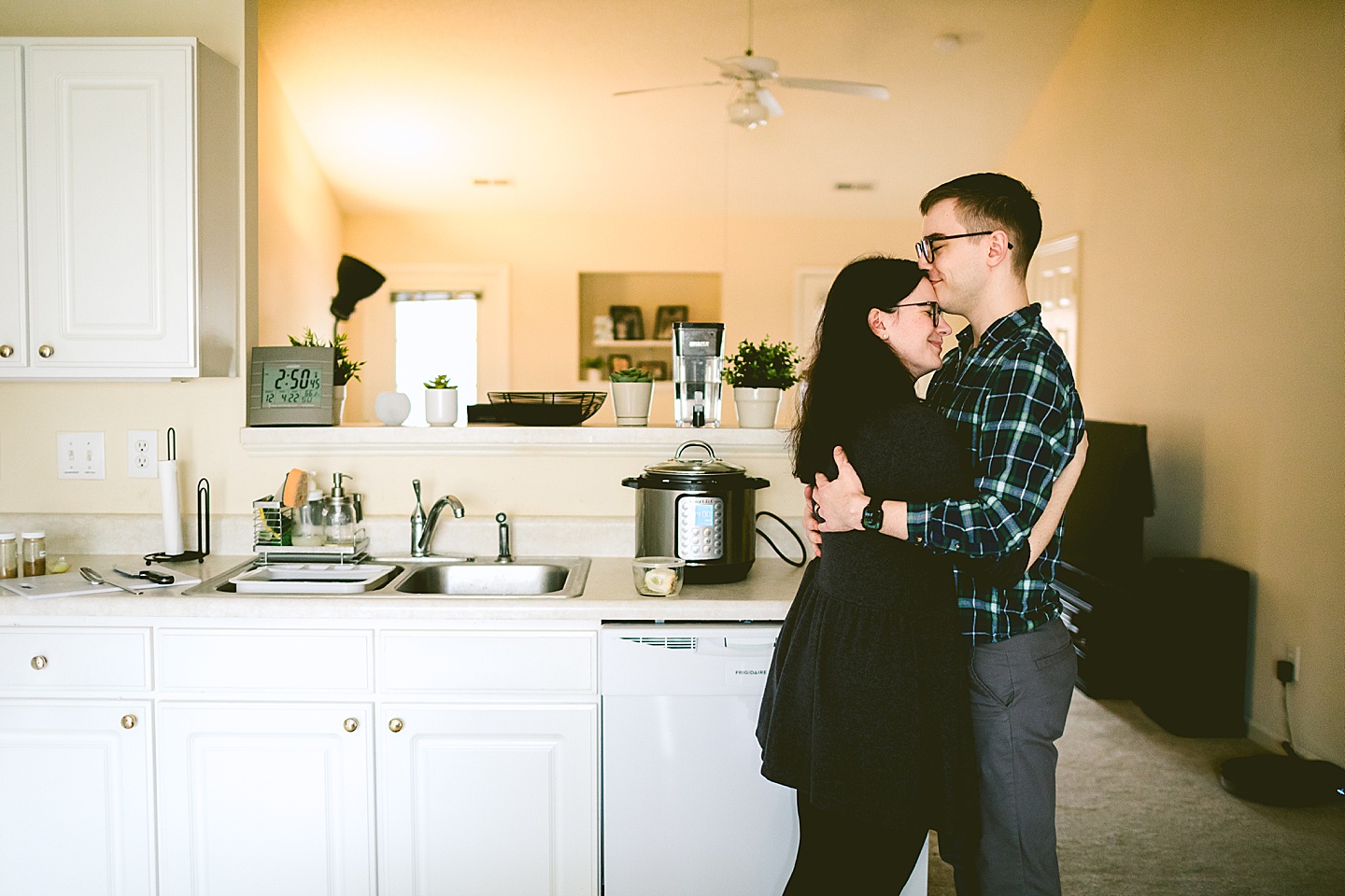 Couple hugging in kitchen at home in Raleigh