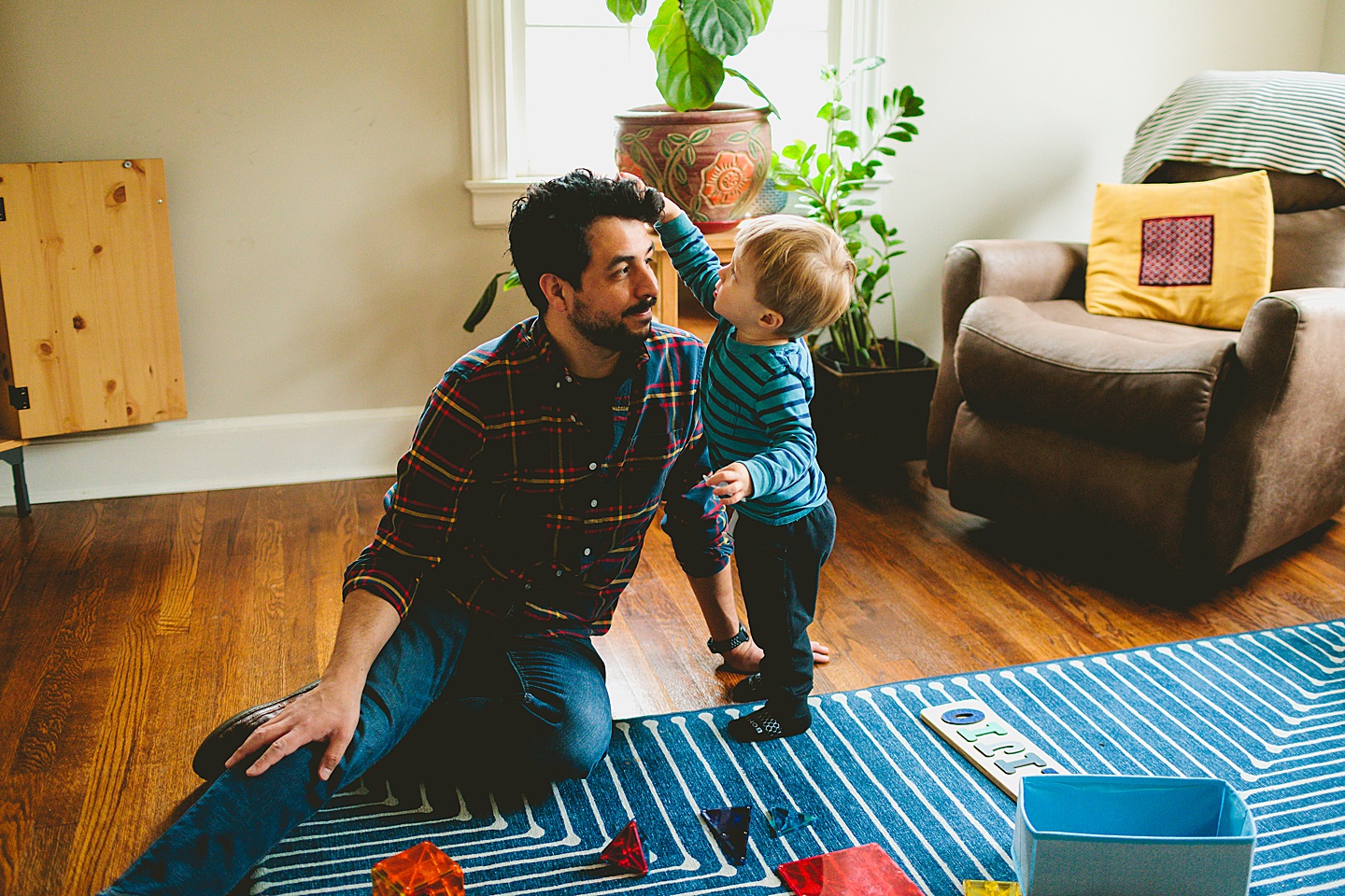 Kid putting sticker on dad's head