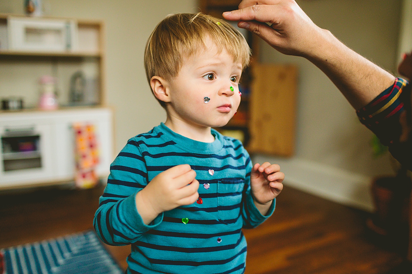 Dad putting gems stickers on kid