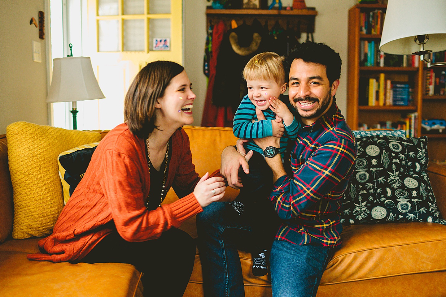 Family on couch in Durham NC during photoshoot