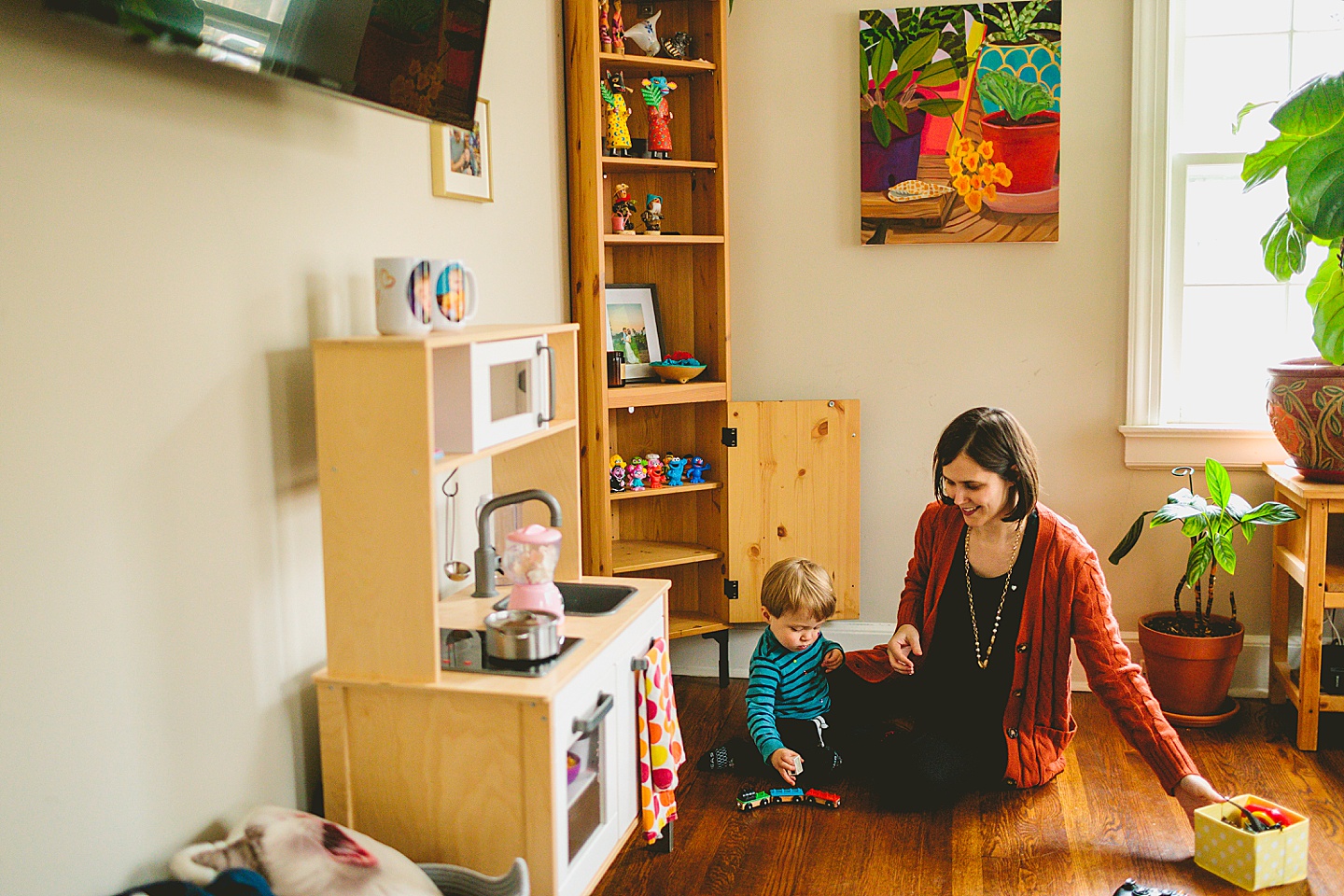 Mother and son sitting on floor playing