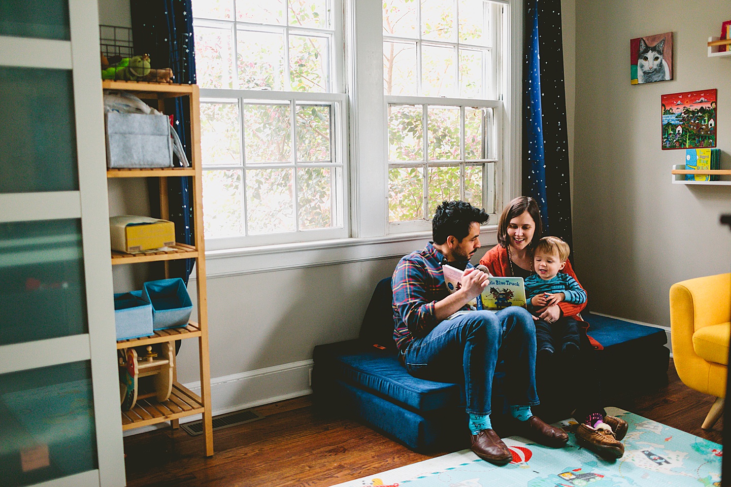 Parents reading to son in bedroom