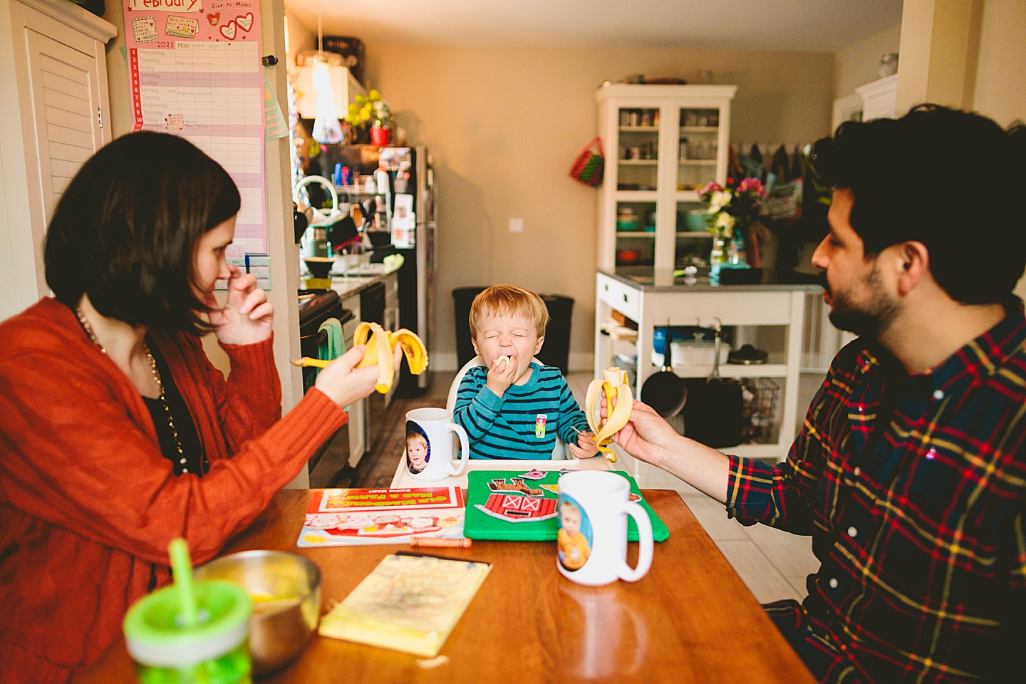 Toddler eating a banana at the table