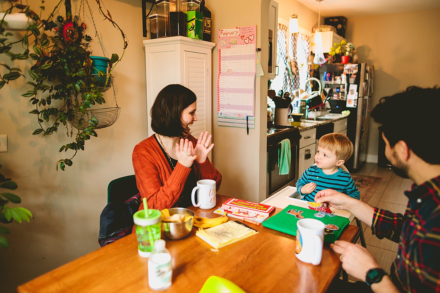 Mom clapping while singing to toddler