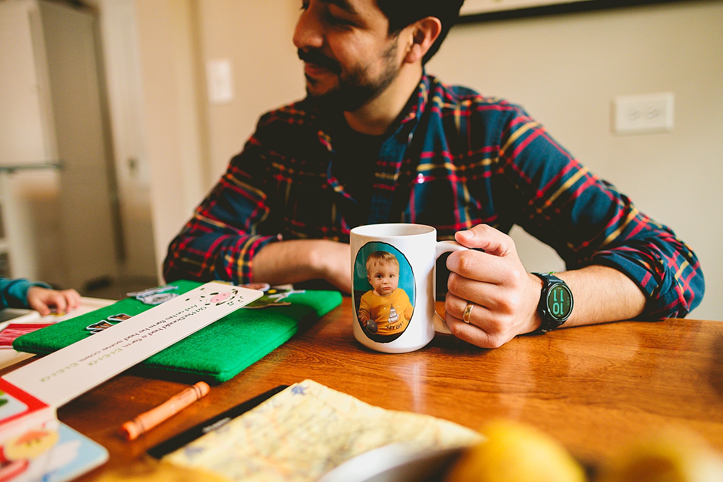 Dad drinking out of mug with kid's face on it