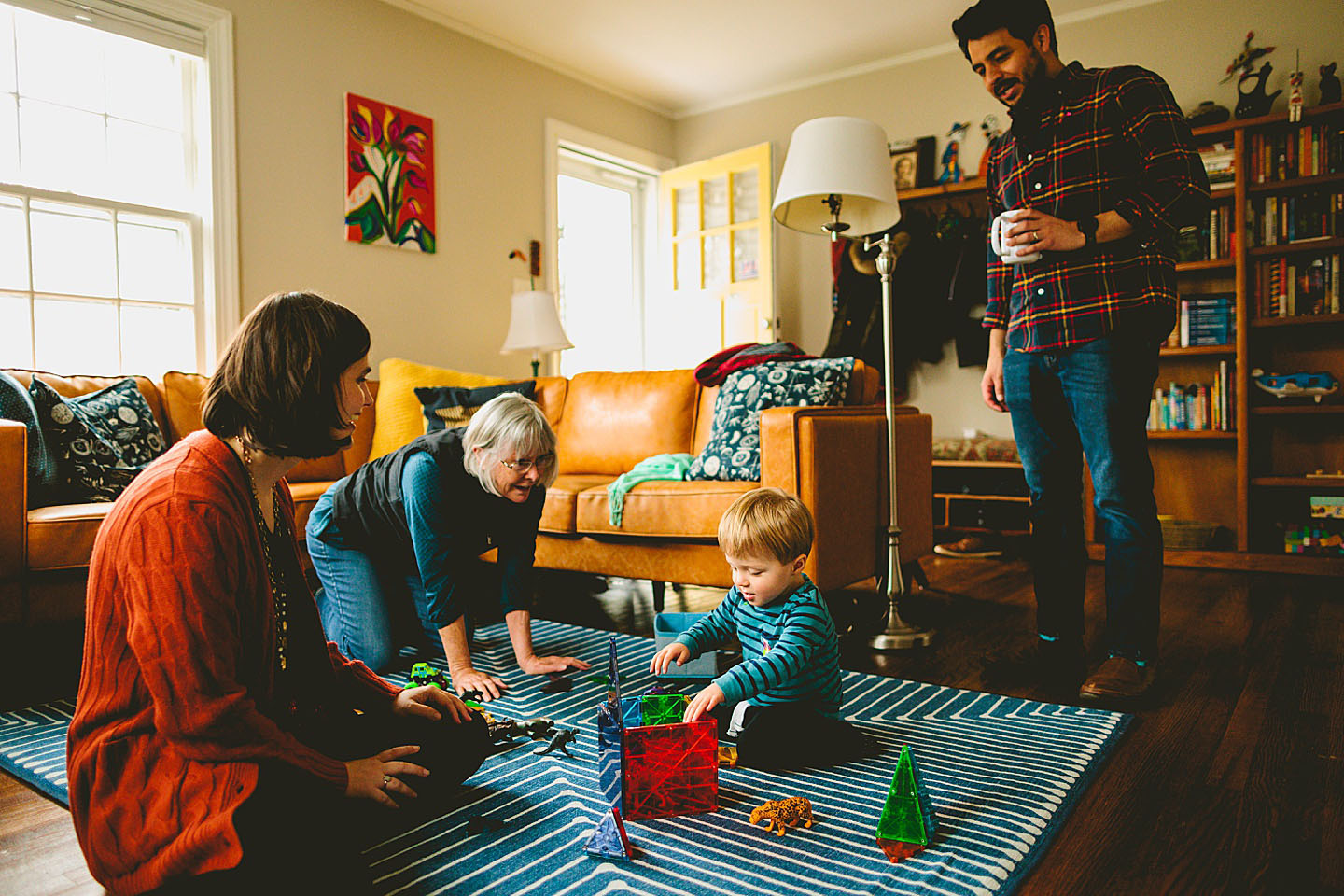 Grandma playing on the floor with grandson in the living room in Durham