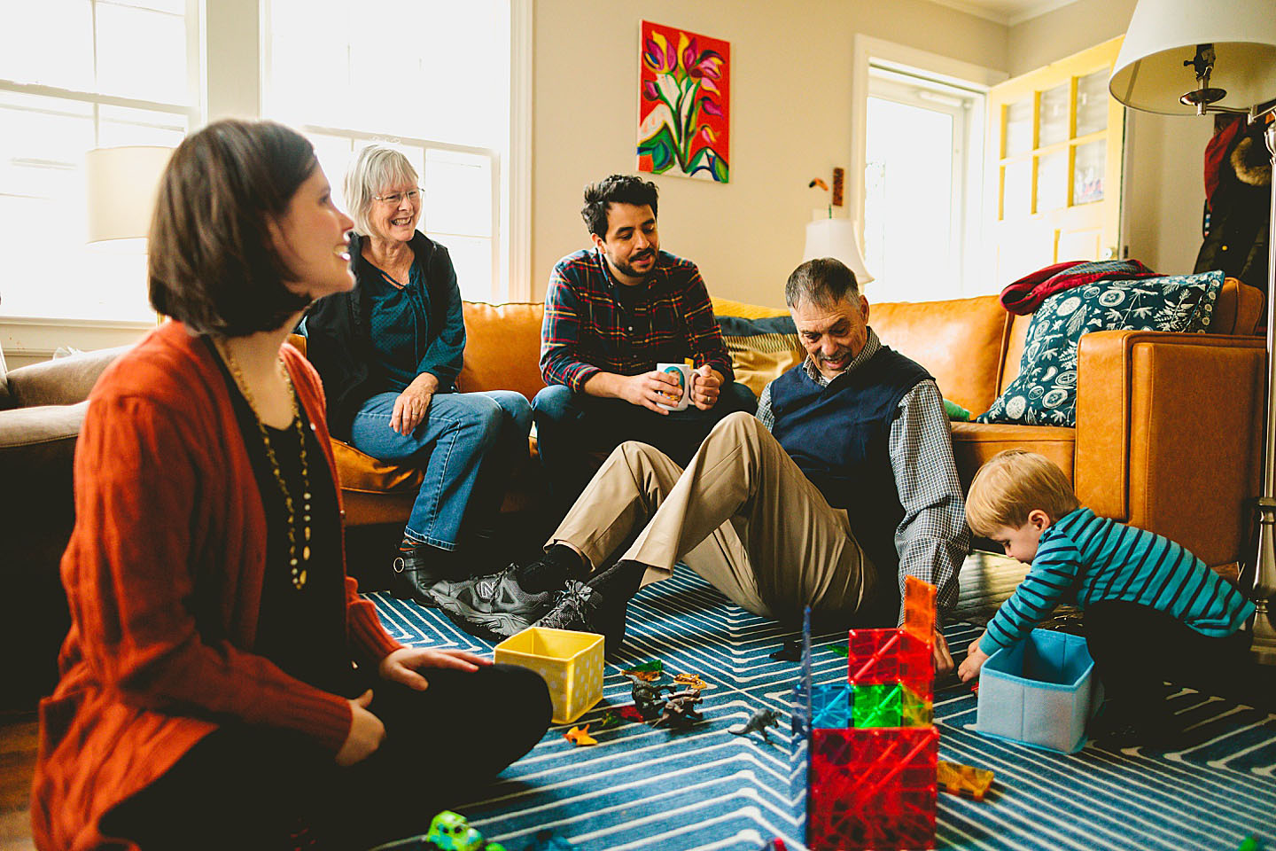 Three generations of family sitting in the living room