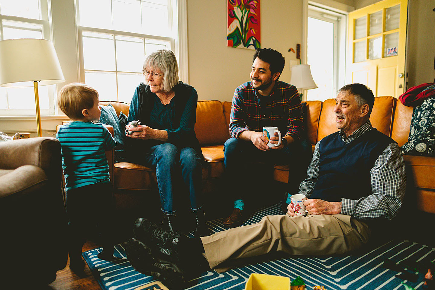 Three generations of family talking on the couch