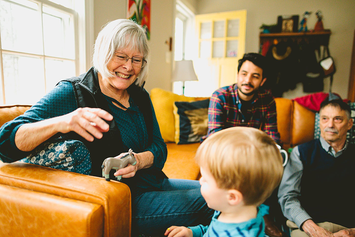 Grandma playing with a donkey toy with grandson