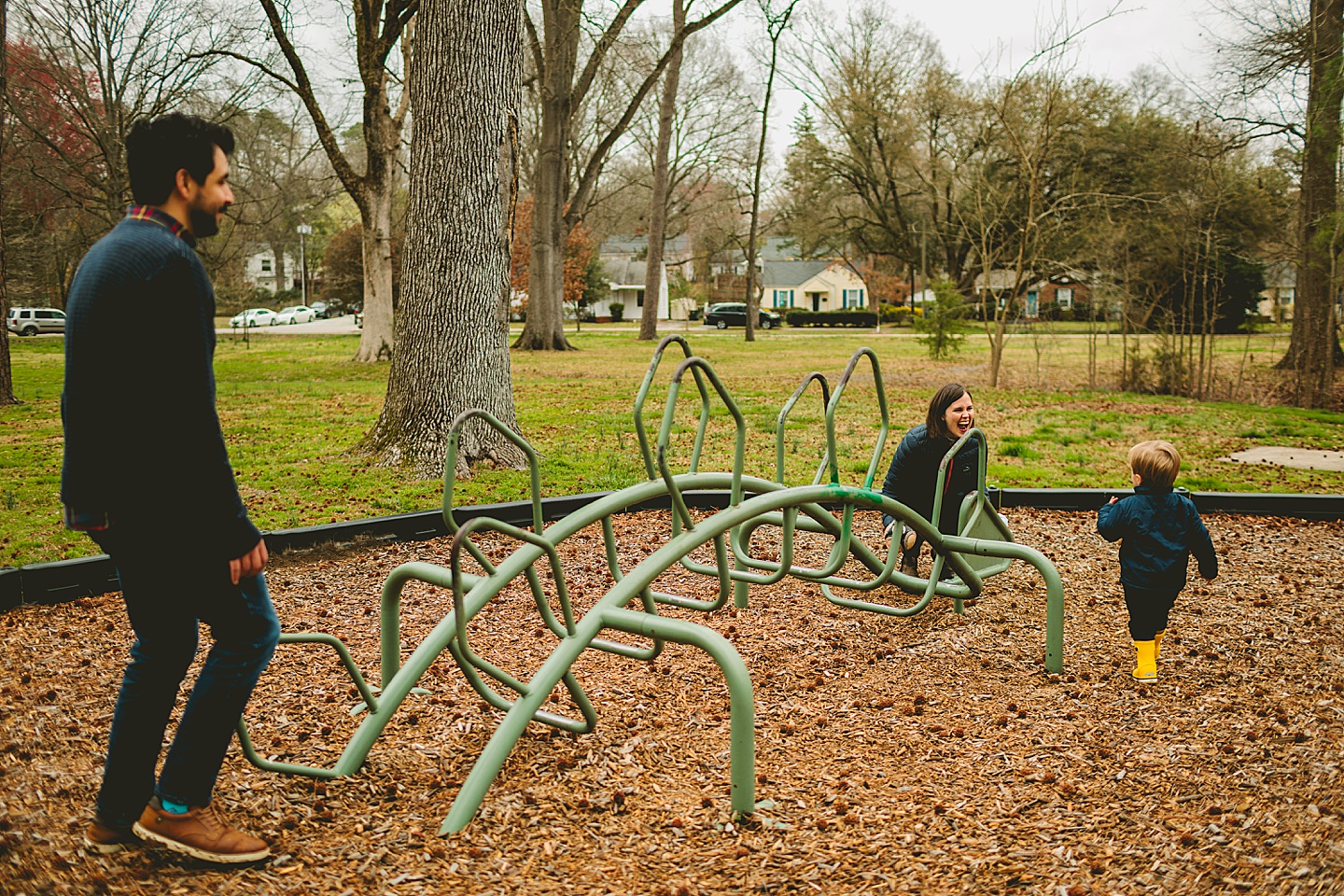 Kid playing with dinosaur sculpture in the park