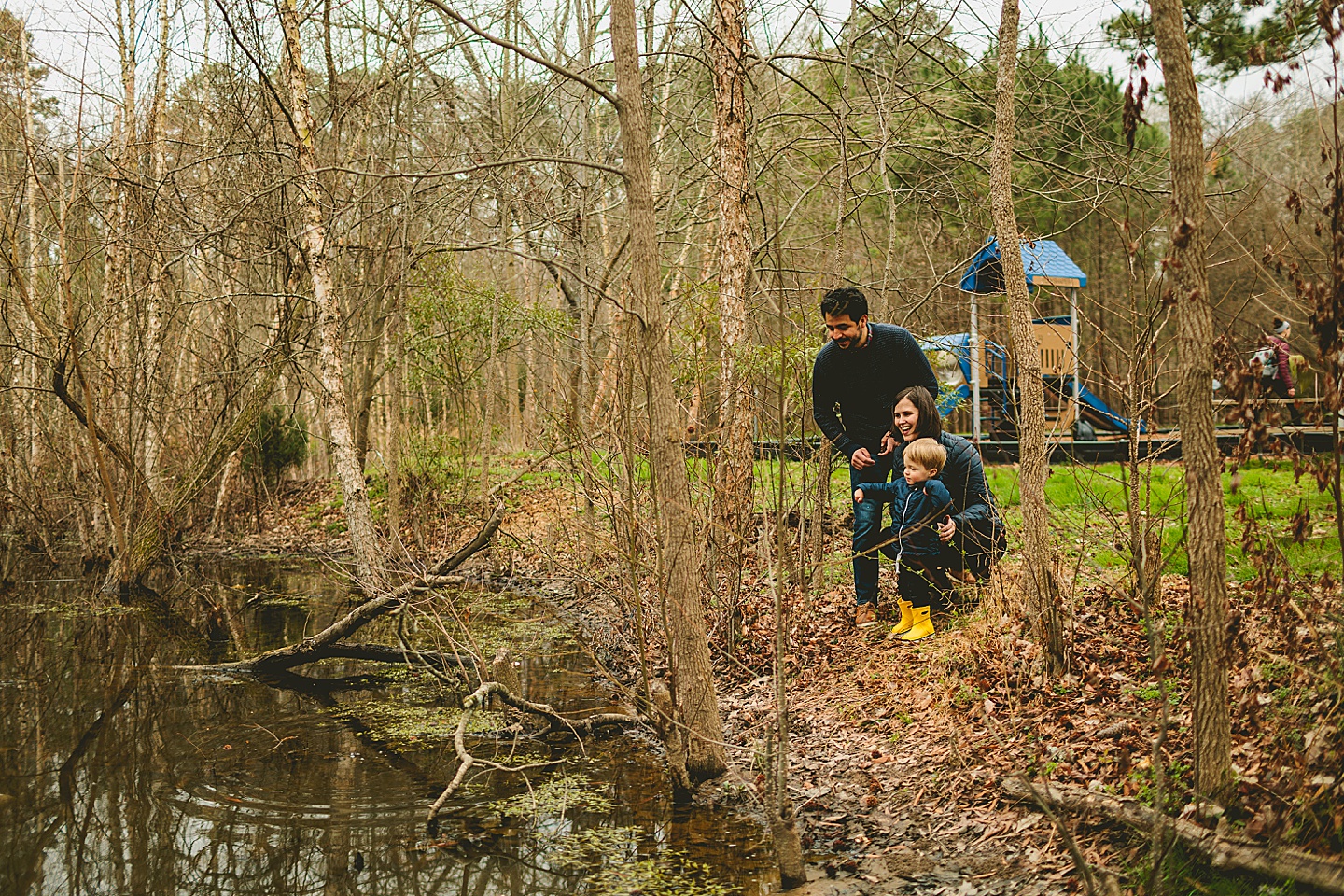 Parents and kid playing at a park in Durham