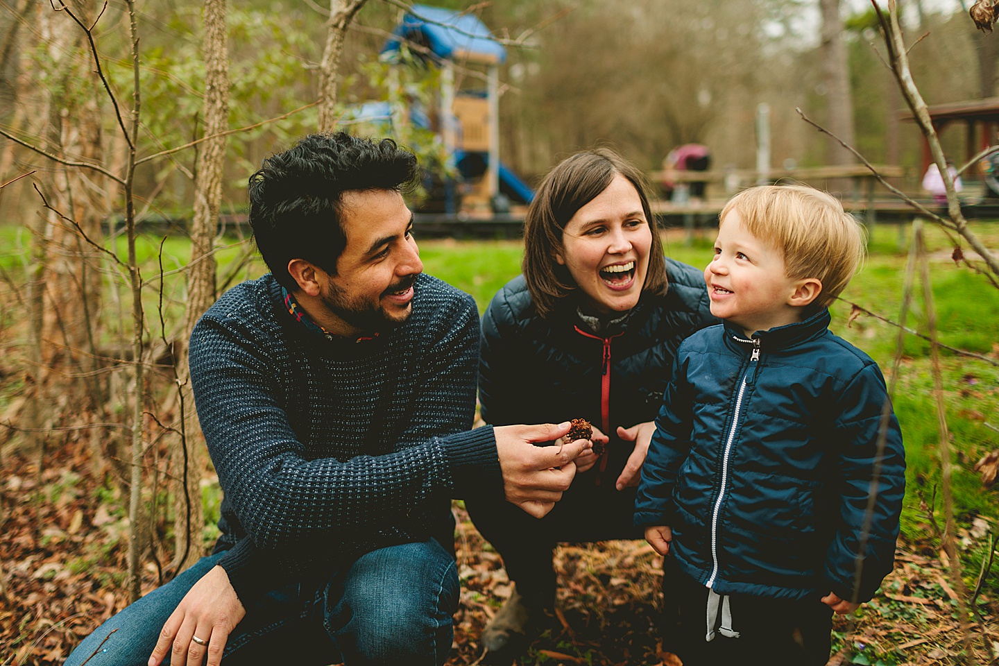 Kid and parents laughing at the park