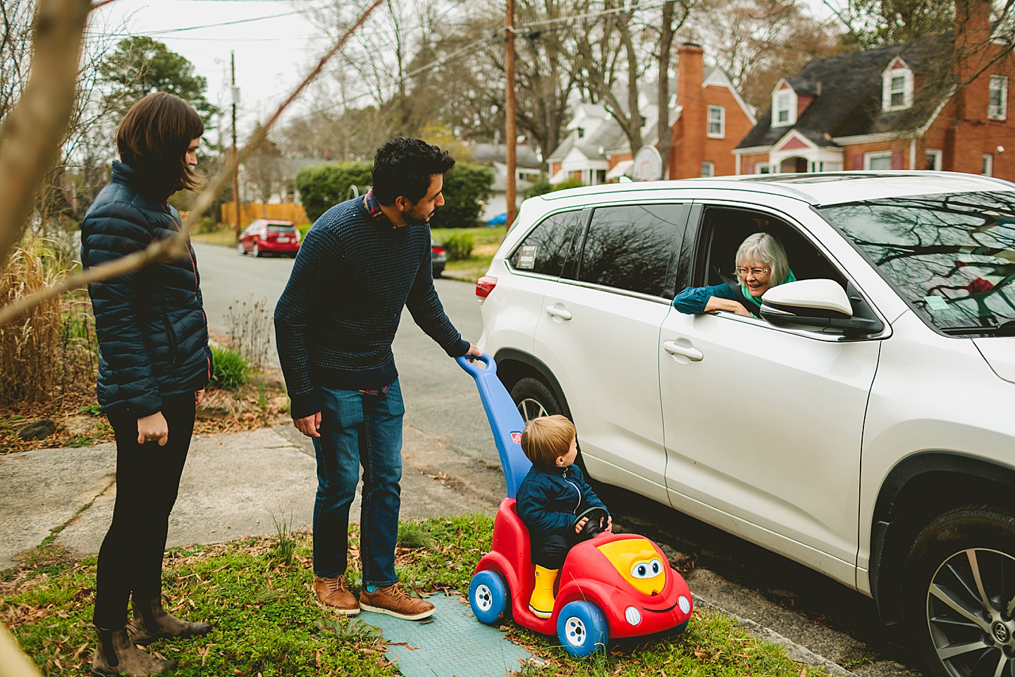 Kid waving goodbye to grandma in a car