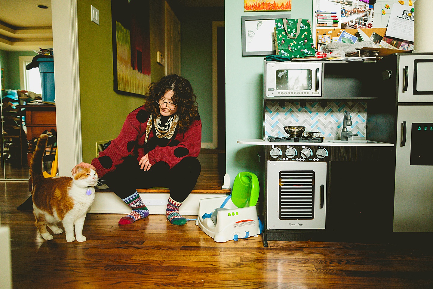 Woman petting orange tabby cat