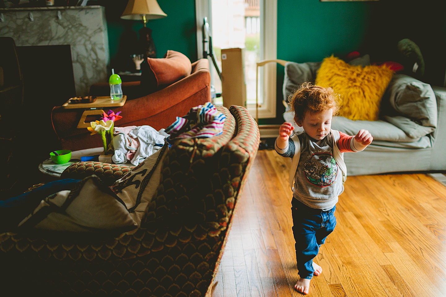 Toddler putting a bookbag on