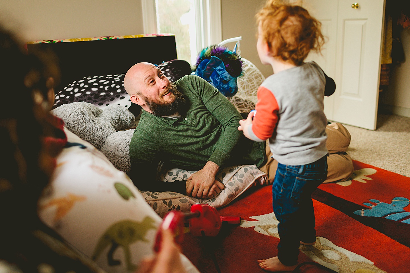 Dad laughing at toddler