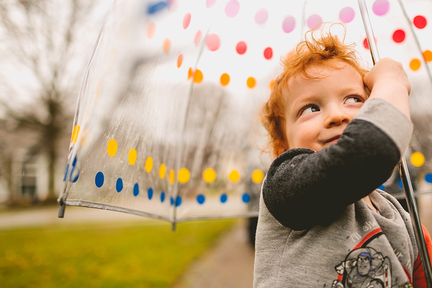 Toddler smiling at umbrella