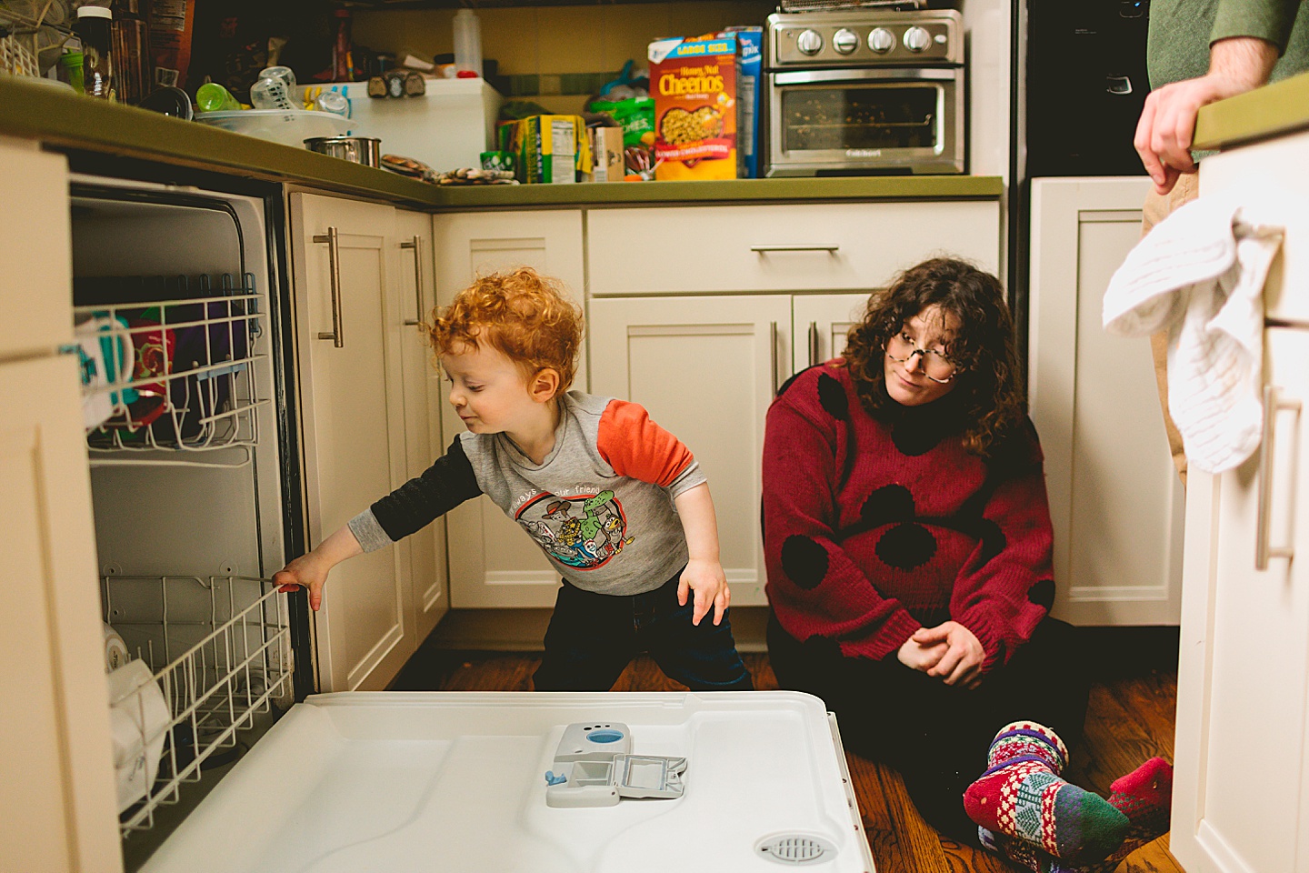 Toddler unloading dishwasher