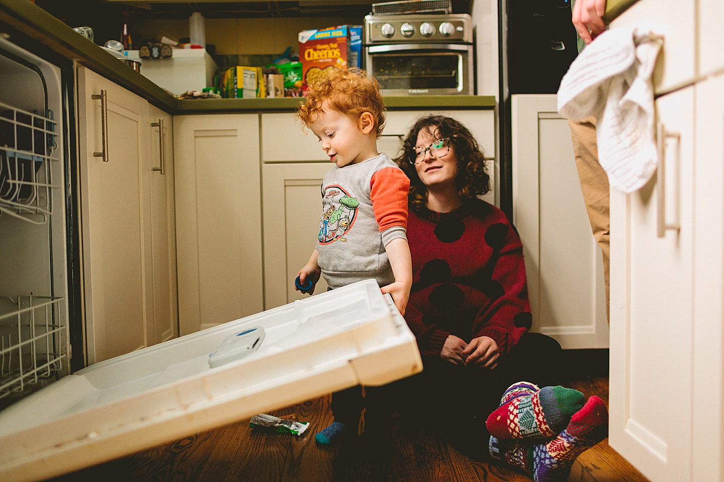 Toddler unloading dishwasher