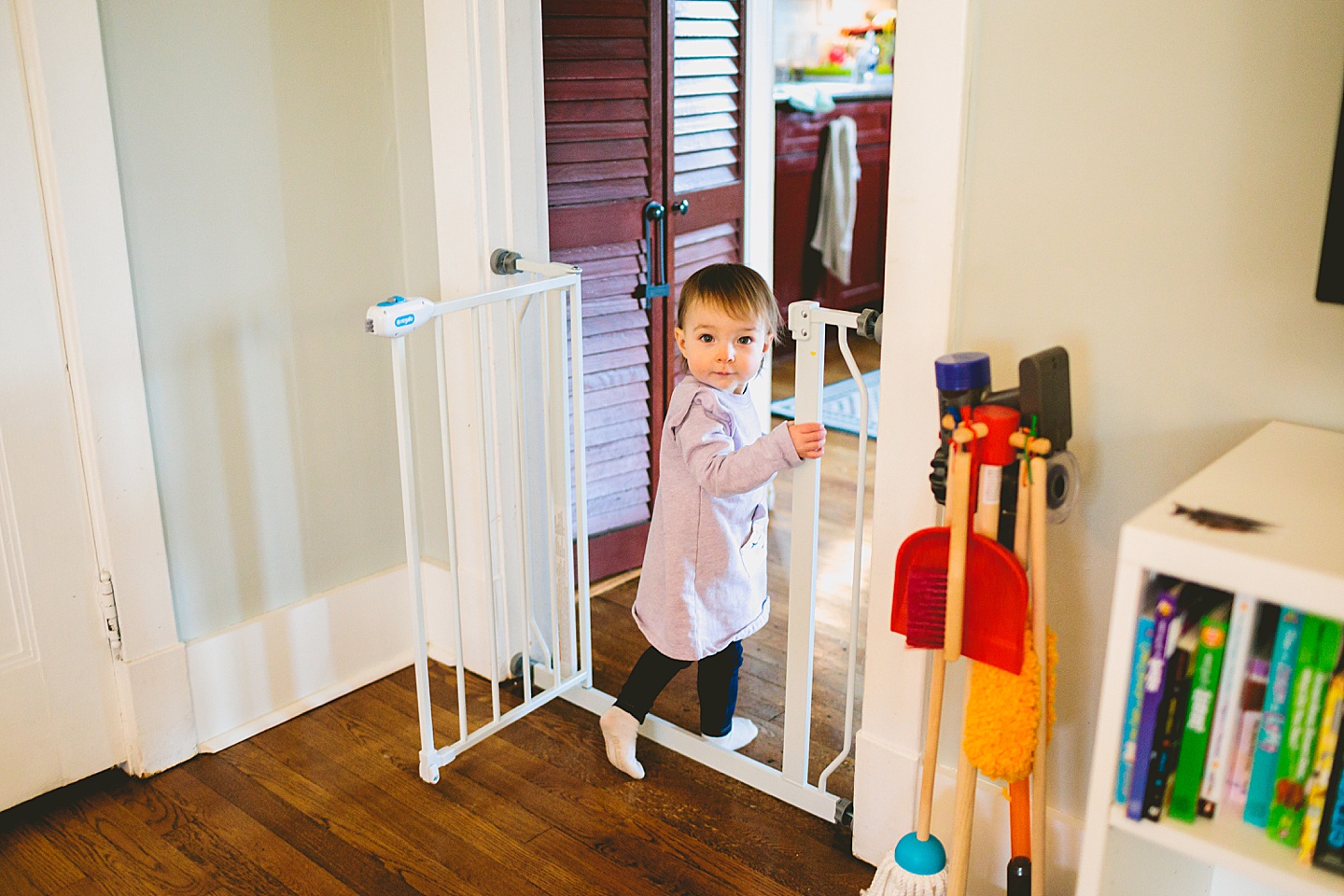 toddler walking through a babygate