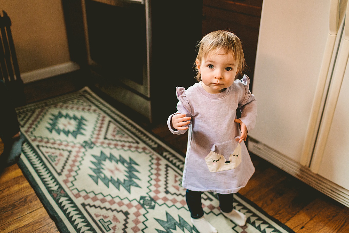 toddler standing in a kitchen