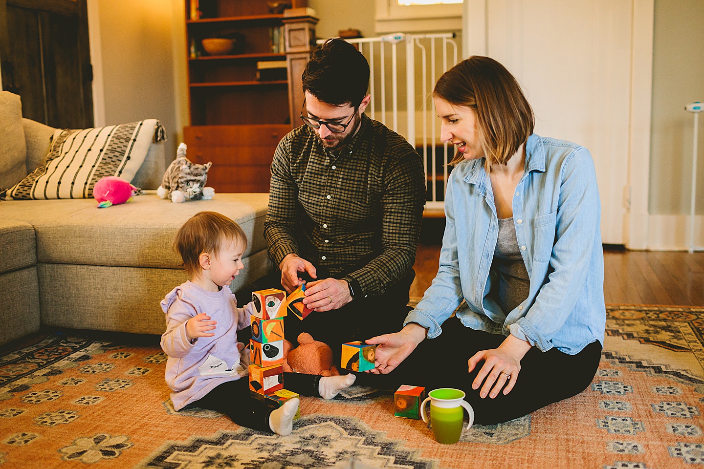 parents playing blocks with young girl