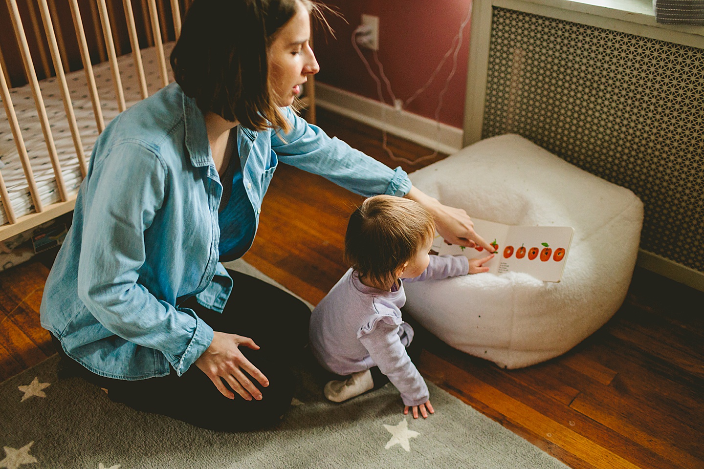 mom reading book to daughter