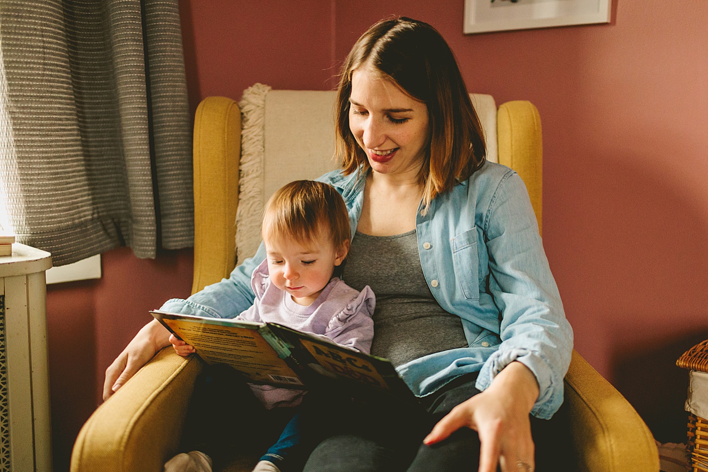 mom reading a book to her daughter