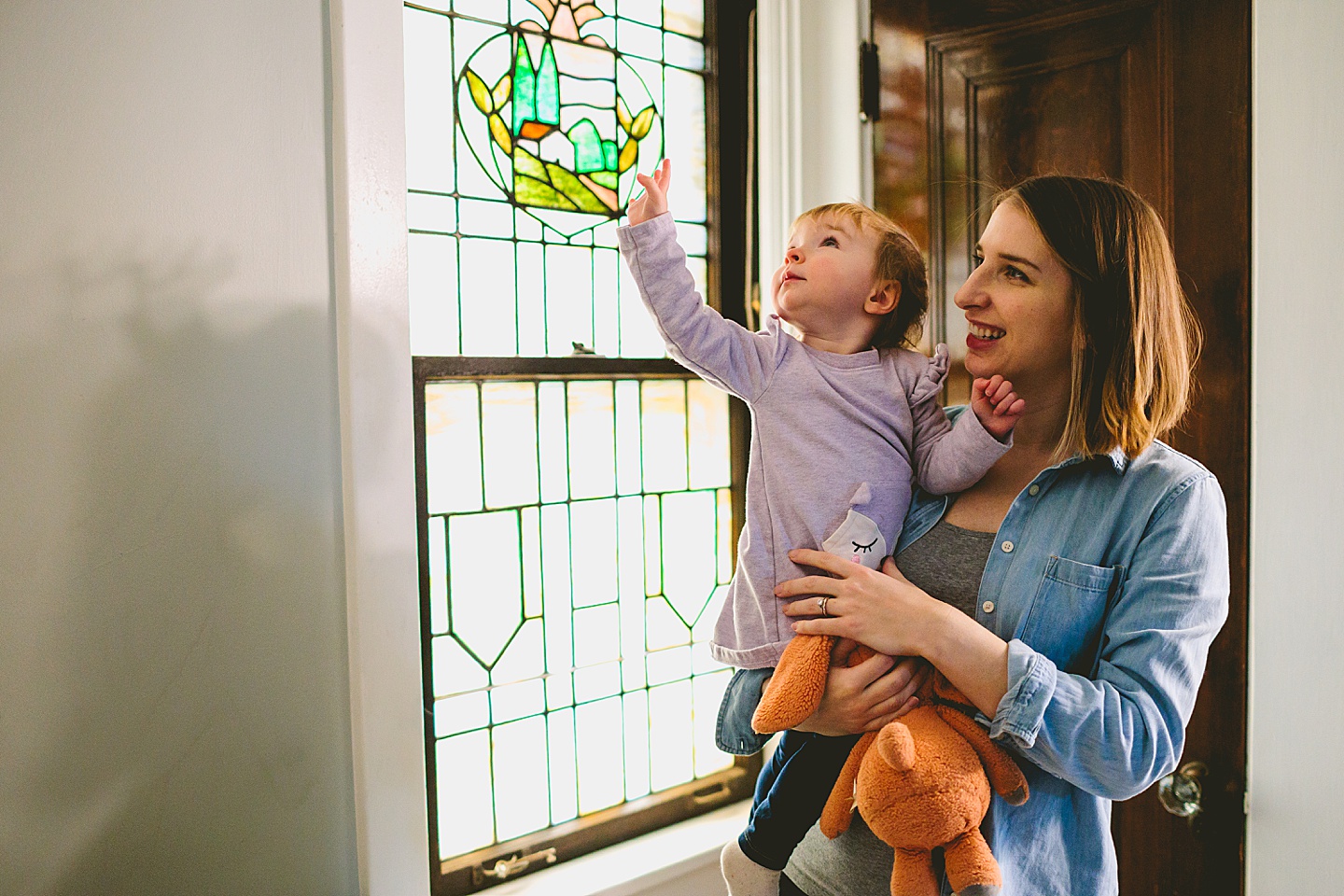 toddler looking at stained glass in house