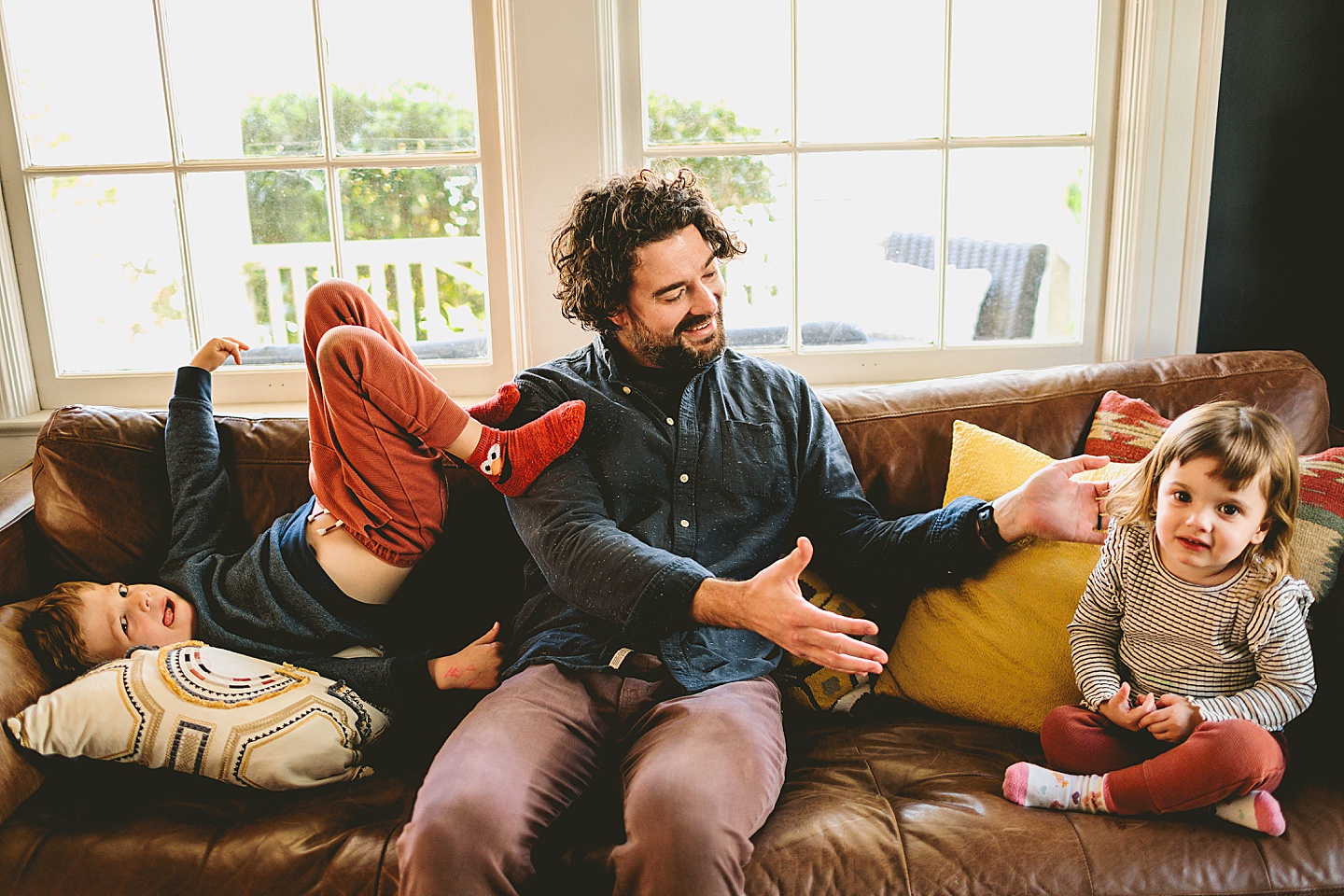 Dad sitting with kids on the couch