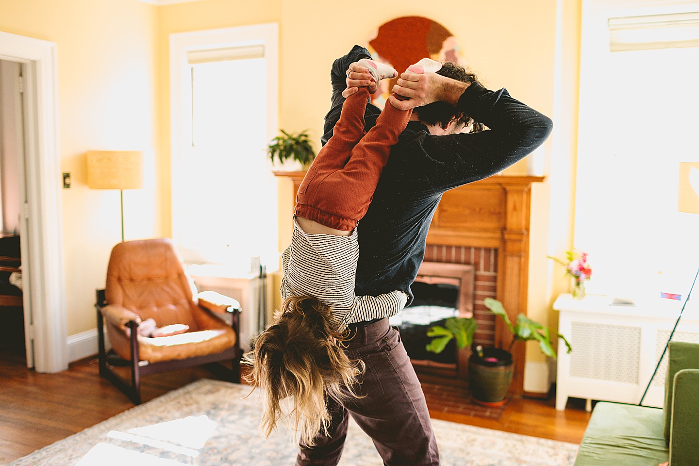 Girl getting turned upside down by dad