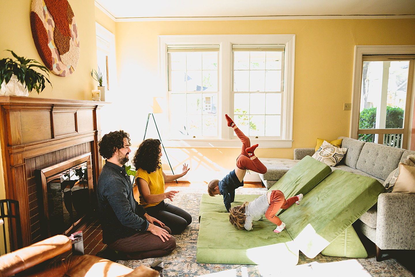 Kids having dance party in the living room during family pictures in Durham NC