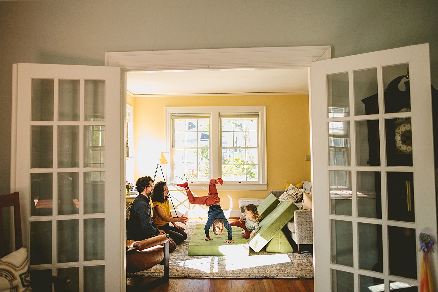 Kids having dance party in the living room during family pictures in Durham NC