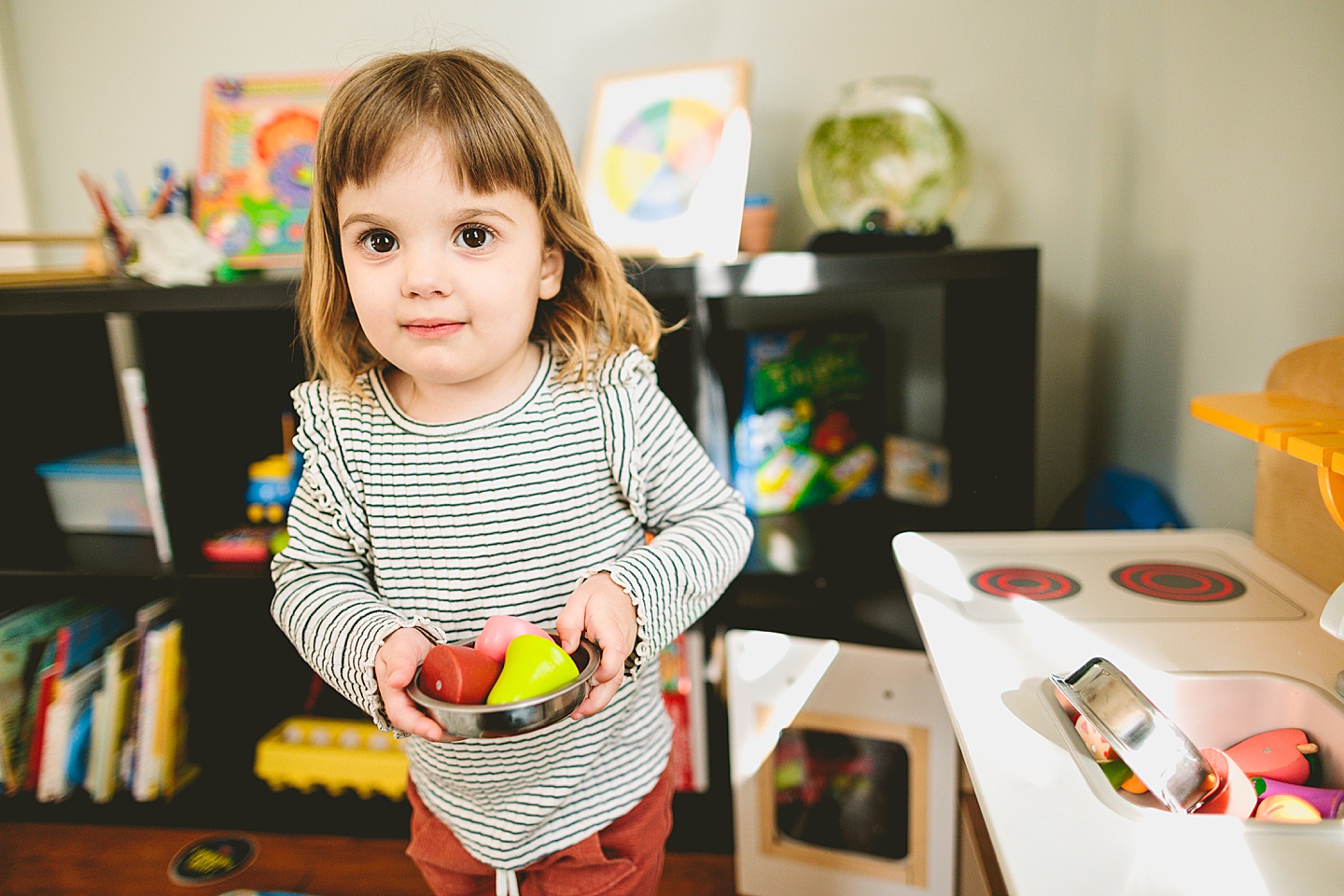 Girl working in pretend play kitchen at home