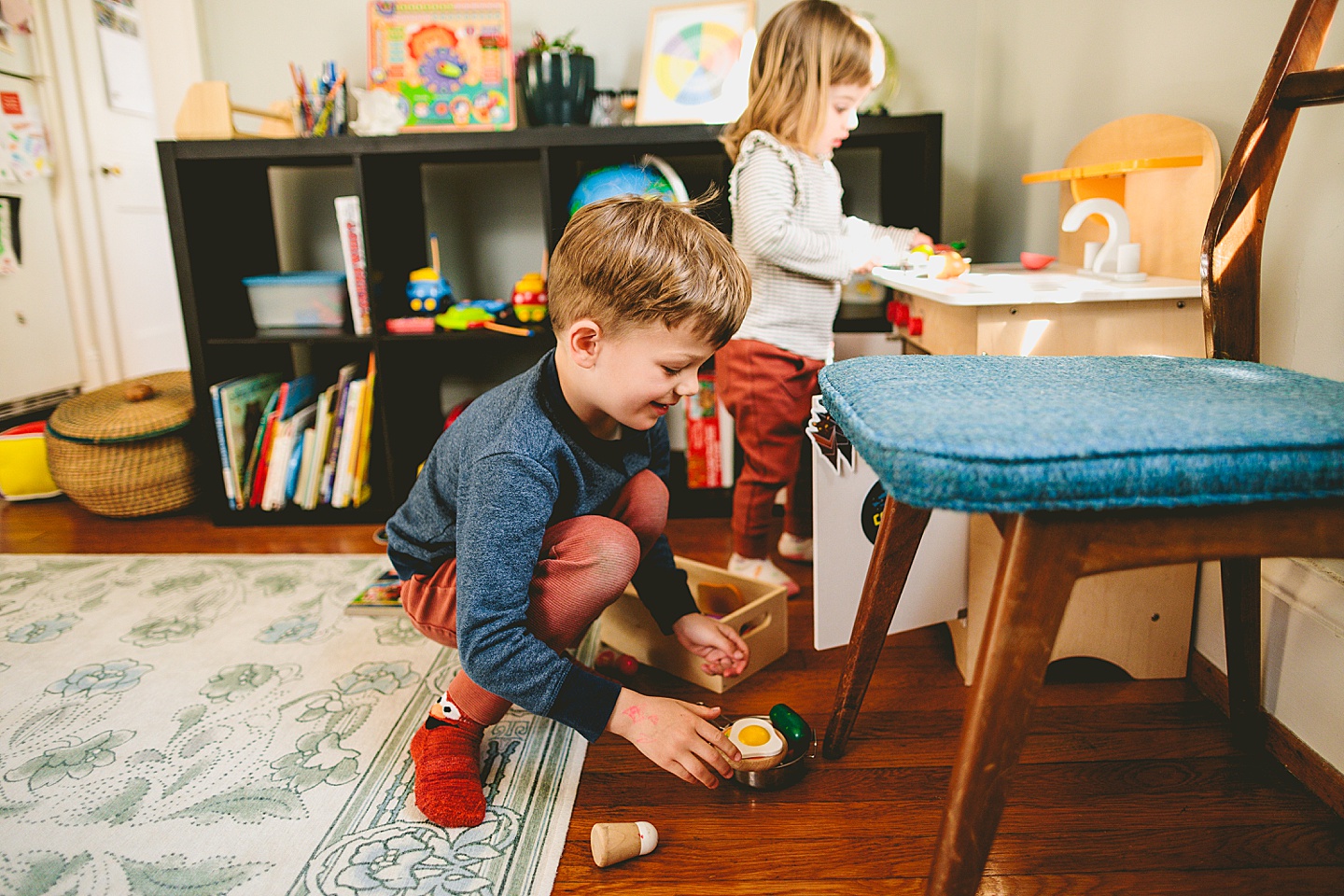 Kids making food in pretend play kitchen