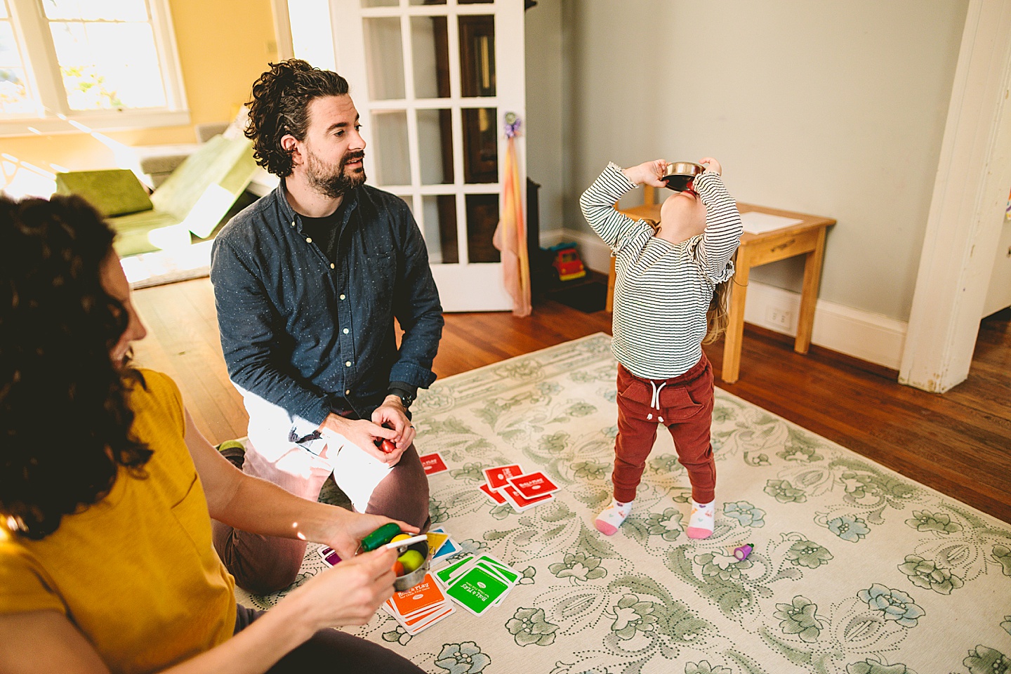 Kids offering pretend play food to parents