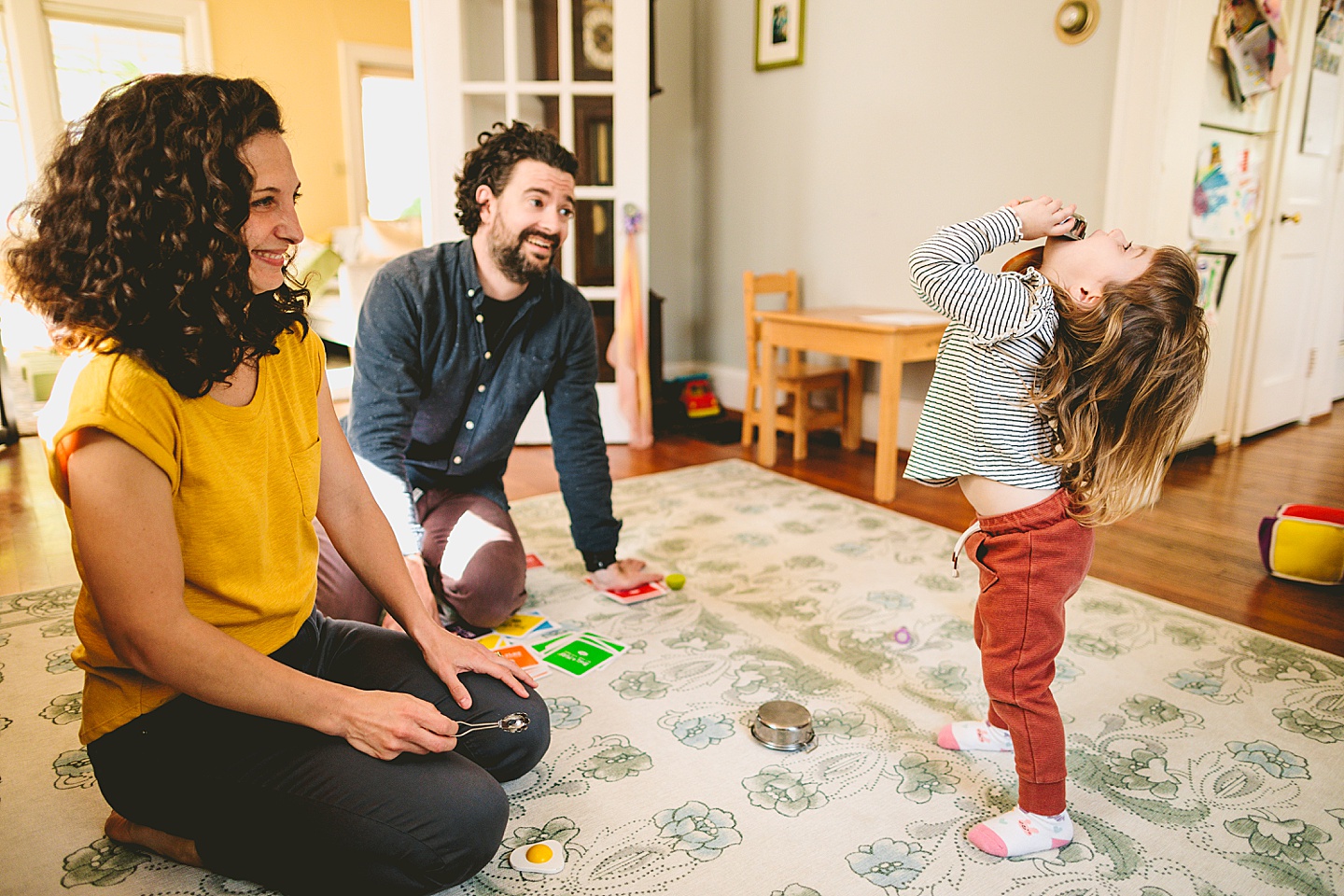 Kids offering pretend play food to parents