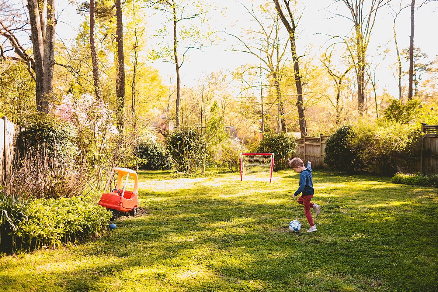 Boy playing soccer in the yard