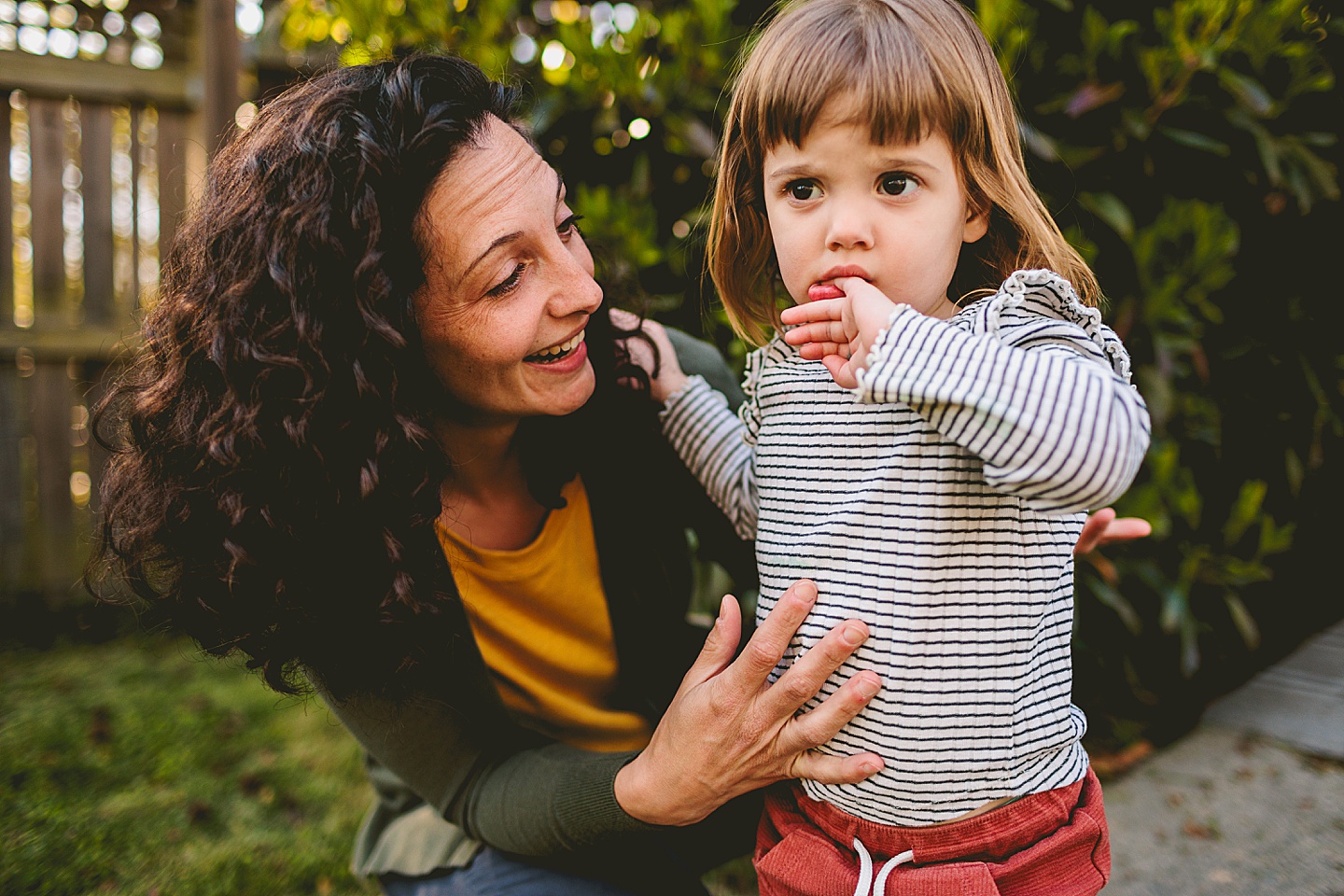 Mom talking to daughter in the backyard